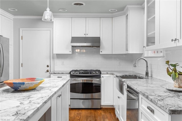 kitchen with white cabinets, appliances with stainless steel finishes, visible vents, and under cabinet range hood