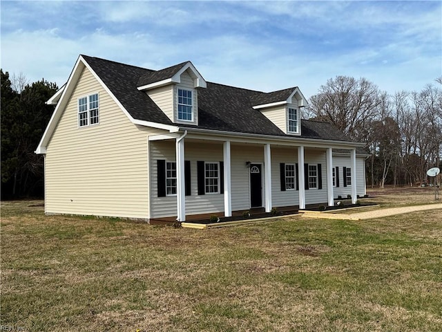 cape cod home with a front yard and a shingled roof