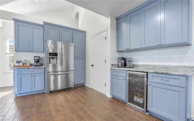 kitchen with beverage cooler, dark wood-style floors, blue cabinetry, and stainless steel fridge with ice dispenser