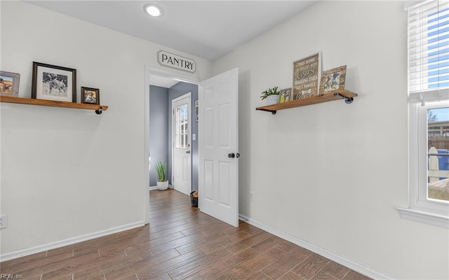 empty room with baseboards and wood finished floors