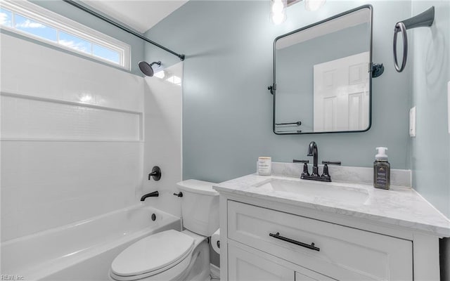 bathroom featuring toilet, shower / washtub combination, and vanity