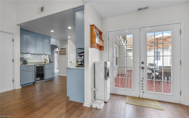 kitchen with visible vents, backsplash, wine cooler, french doors, and dark wood-style flooring