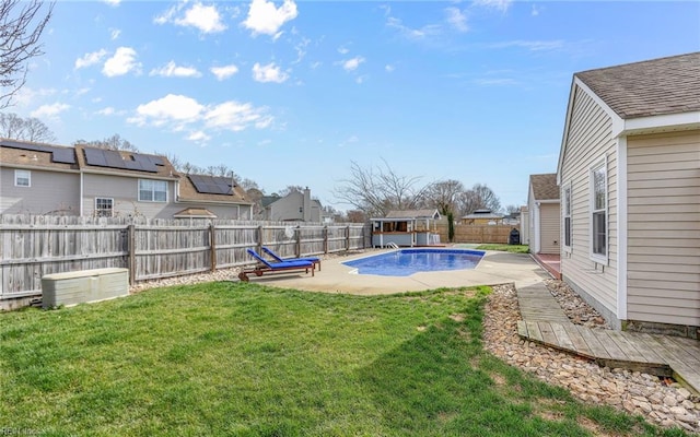 view of yard with a fenced in pool, a residential view, a patio, and a fenced backyard