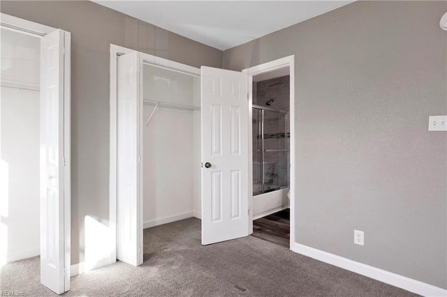 unfurnished bedroom featuring carpet flooring, baseboards, and a closet