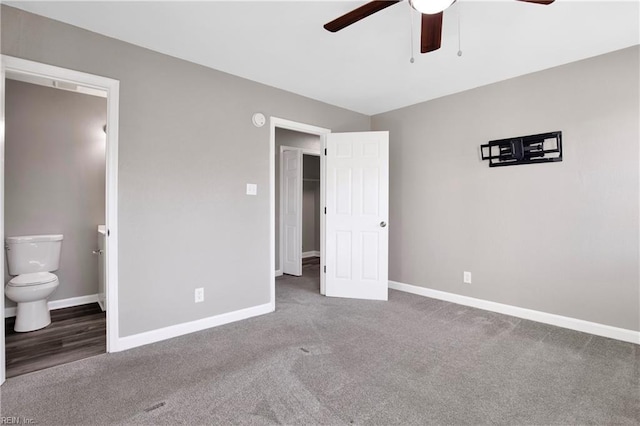 unfurnished bedroom featuring baseboards, carpet floors, and ensuite bathroom