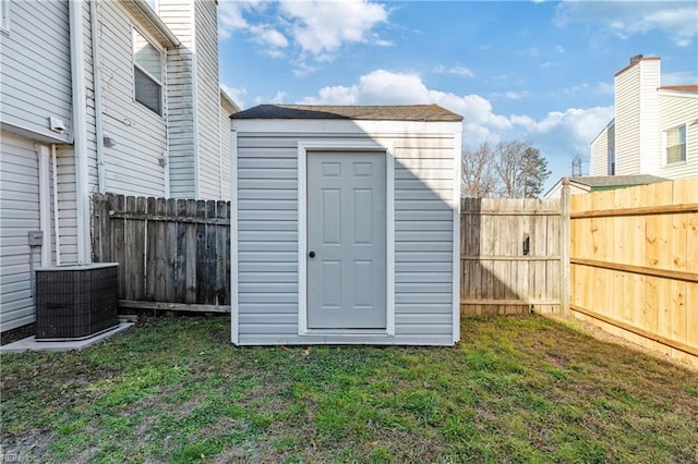 view of shed featuring cooling unit and a fenced backyard