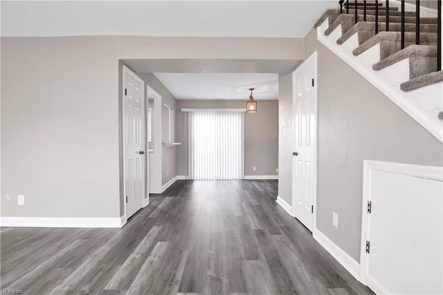 interior space featuring stairway, baseboards, and wood finished floors