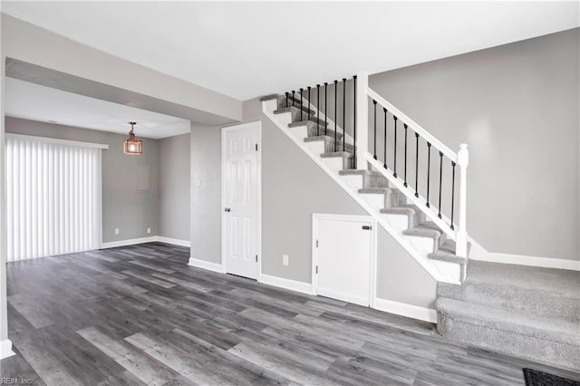 interior space with wood finished floors and baseboards