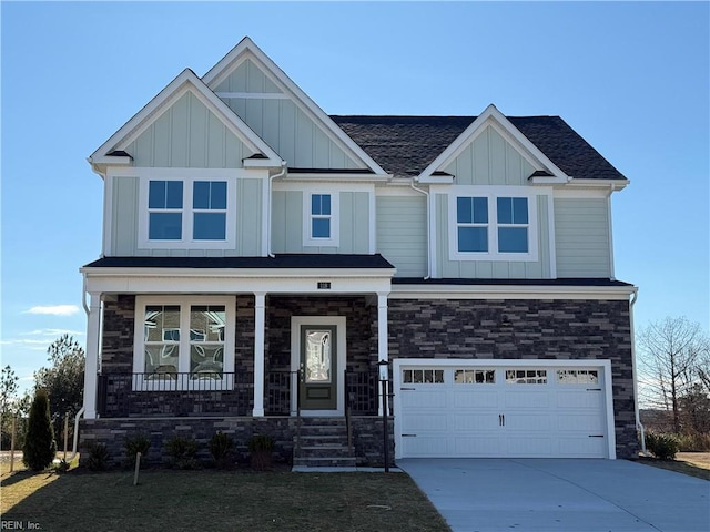 craftsman house featuring driveway, covered porch, board and batten siding, and an attached garage