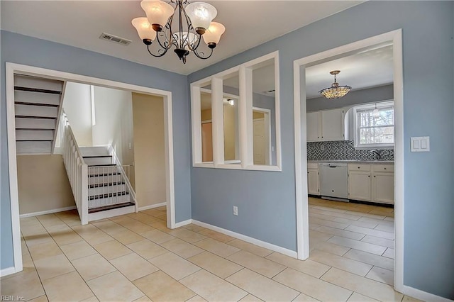 spare room featuring visible vents, stairway, an inviting chandelier, light tile patterned floors, and baseboards