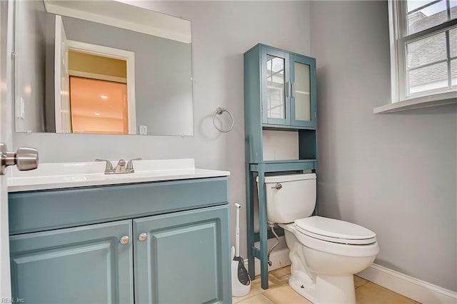 bathroom with vanity, tile patterned floors, toilet, and baseboards