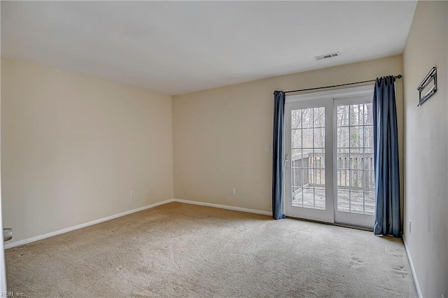 unfurnished room with baseboards, visible vents, and carpet floors