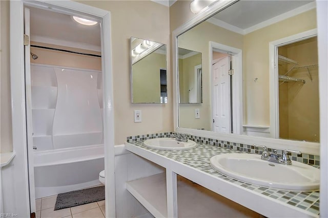 bathroom with tile patterned flooring, double vanity, toilet, and a sink