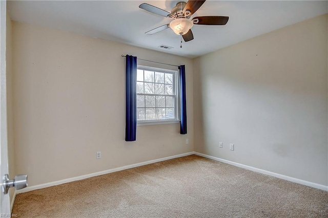 unfurnished room featuring visible vents, carpet floors, baseboards, and a ceiling fan