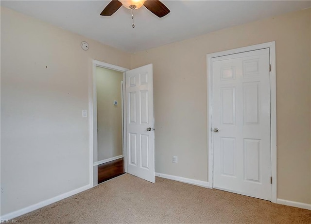 unfurnished bedroom featuring baseboards, carpet floors, and ceiling fan