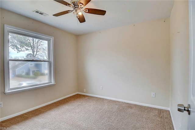 empty room featuring visible vents, baseboards, carpet, and ceiling fan