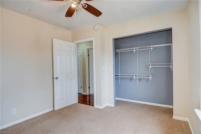 unfurnished bedroom featuring carpet flooring, baseboards, a closet, and ceiling fan