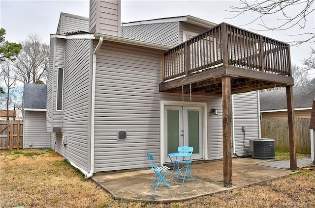 back of house with a patio area, central AC unit, a chimney, and fence