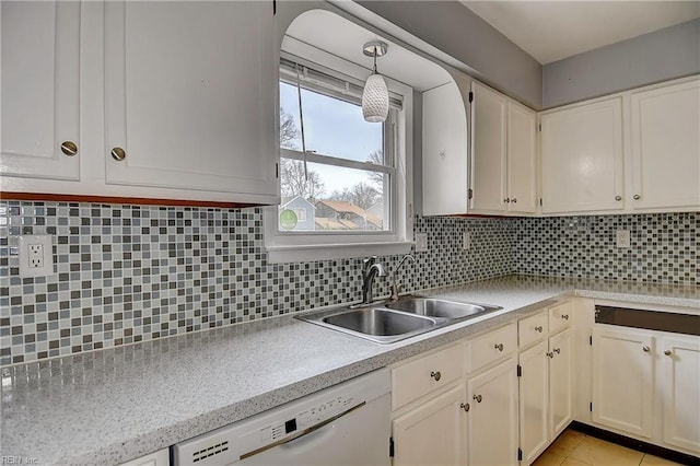 kitchen with a sink, decorative backsplash, dishwasher, and light countertops