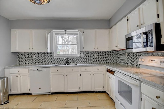 kitchen with decorative backsplash, white appliances, white cabinetry, and a sink