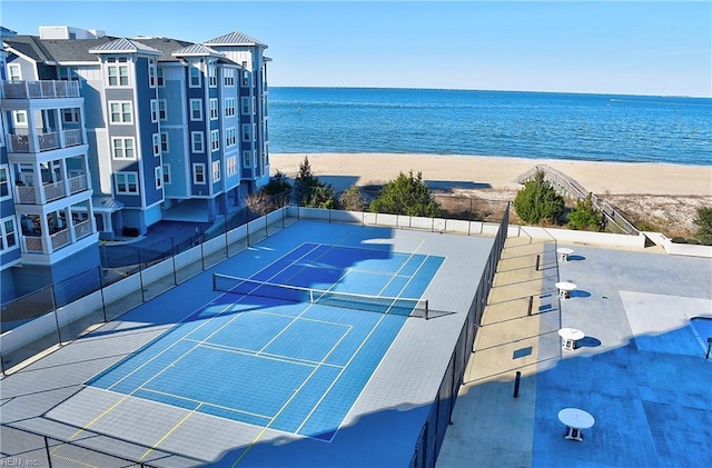 bird's eye view featuring a water view and a beach view