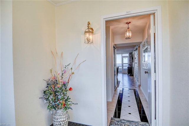 hallway featuring light tile patterned floors and baseboards