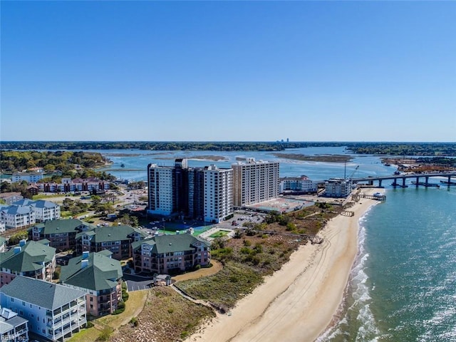 birds eye view of property featuring a view of city, a beach view, and a water view