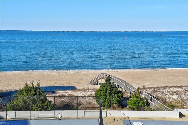 water view with a beach view and fence