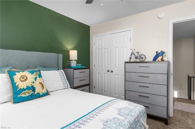 bedroom with a closet, a ceiling fan, and carpet flooring