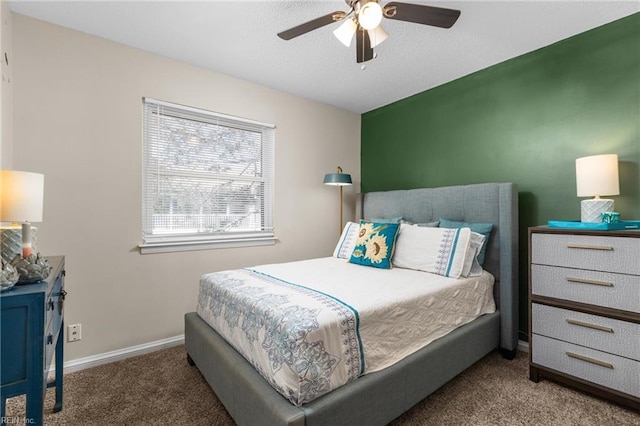 bedroom with a textured ceiling, baseboards, carpet floors, and ceiling fan