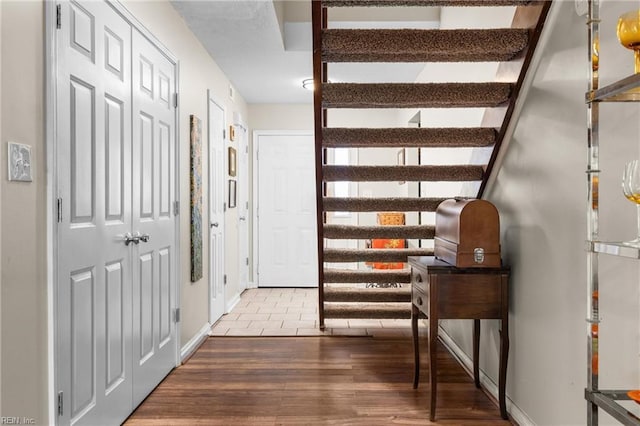 corridor with wood finished floors and baseboards