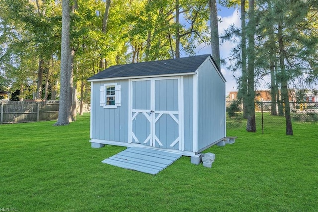 view of shed with a fenced backyard