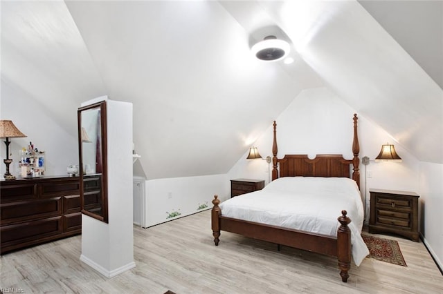 bedroom with lofted ceiling, wood finished floors, and baseboards