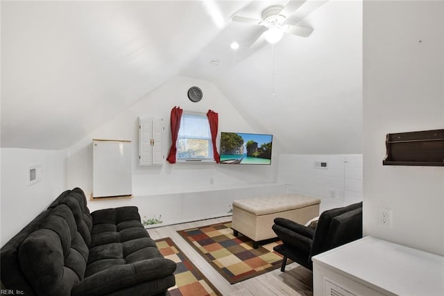 living room featuring light wood-type flooring and lofted ceiling