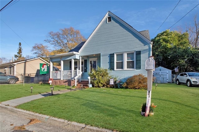 bungalow-style house featuring a porch, a front yard, and fence