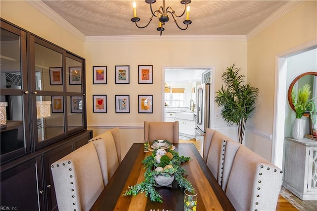 dining room featuring a notable chandelier, wood finished floors, and ornamental molding