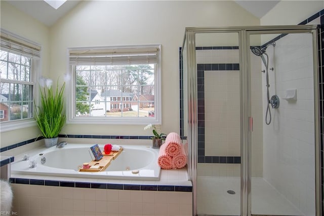 bathroom with a bath, a shower stall, and vaulted ceiling