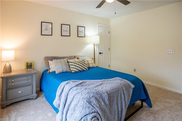 carpeted bedroom featuring baseboards and ceiling fan