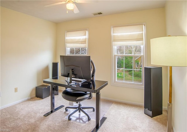 office with visible vents, carpet floors, baseboards, and a ceiling fan