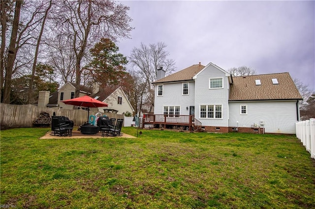 back of house with a patio area, a chimney, a yard, a fenced backyard, and crawl space