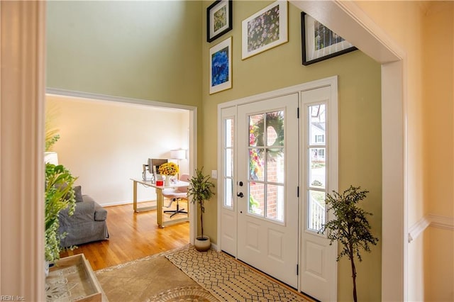 tiled entryway featuring a high ceiling