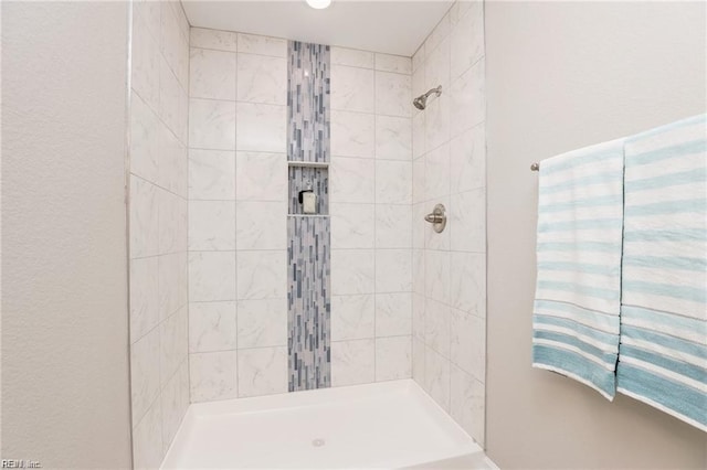 bathroom with a tile shower