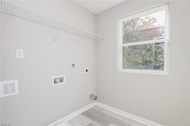 washroom with visible vents, baseboards, hookup for an electric dryer, laundry area, and washer hookup