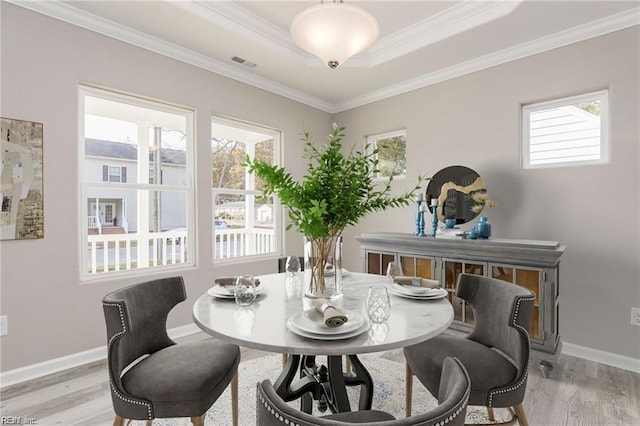 dining space with visible vents, light wood-style floors, and a healthy amount of sunlight