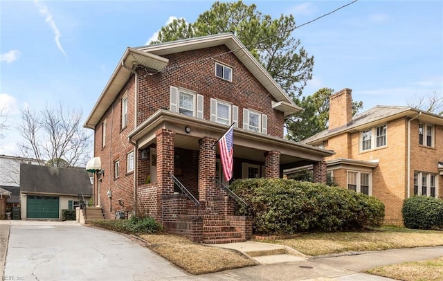 view of front of property featuring a garage, brick siding, an outdoor structure, and concrete driveway