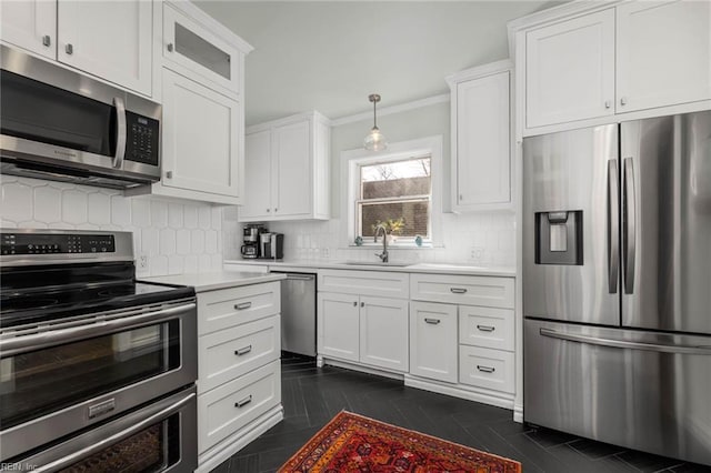 kitchen featuring backsplash, stainless steel appliances, light countertops, and a sink