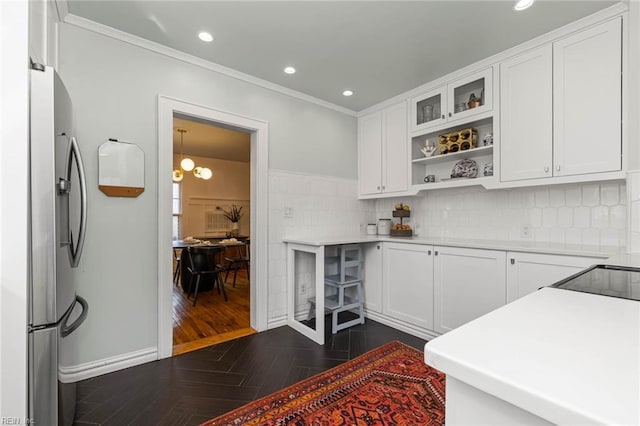 kitchen featuring recessed lighting, white cabinets, and freestanding refrigerator