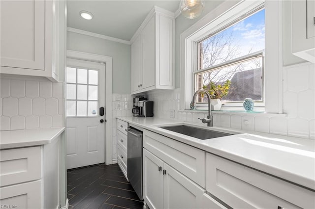 kitchen with a sink, decorative backsplash, light countertops, dishwasher, and white cabinetry