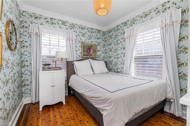 bedroom with wallpapered walls, crown molding, and wood finished floors