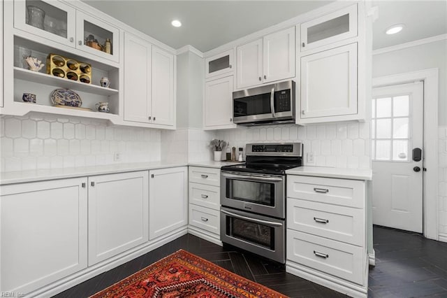 kitchen featuring appliances with stainless steel finishes, white cabinetry, light countertops, and open shelves